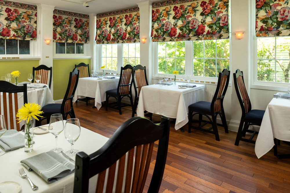 Interior of Ashby Inn & Restaurant with tables near a wall of windows